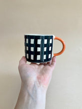Load image into Gallery viewer, Monochrome Gingham Mug - Orange Handle
